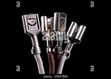 Metal connectors mounted on the ends of the cables. Accessories used in electrical installations. Isolated background. Stock Photo