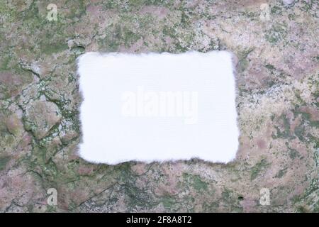 Blank white torn paper on top of stone surface. Flat lay, top view. Stock Photo