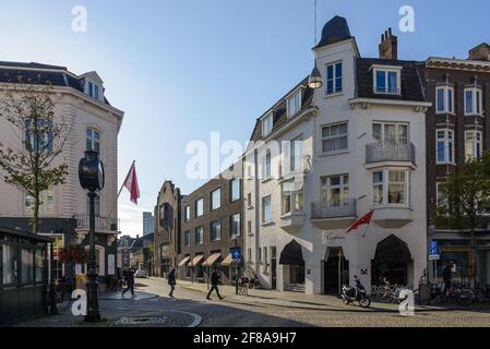 Outdoor sunny view  along Stationsstraat and Wycker Brugstraat street surrounded with retail shops, cafes and restaurants in Maastricht, Netherlands. Stock Photo