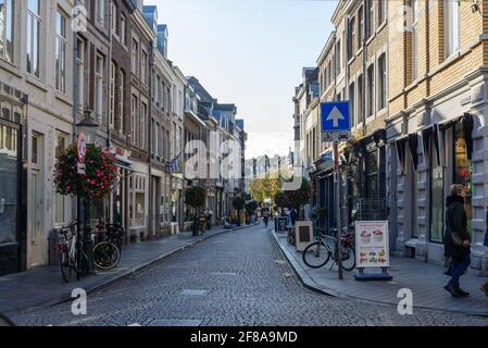 Outdoor sunny view  along Stationsstraat and Wycker Brugstraat street surrounded with retail shops, cafes and restaurants in Maastricht, Netherlands. Stock Photo