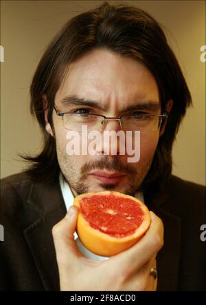 Jerome Taylor tries MIRACLE FRUIT ( Synsepalum Dulcificum) which makes sour and bitter foods taste sweeter.photograph by David Sandison The Independent Stock Photo