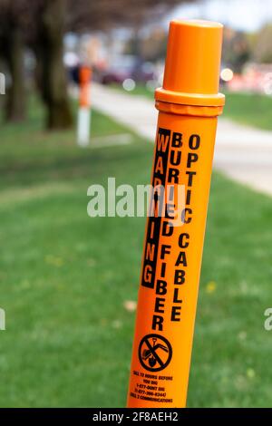 Troy, Michigan - A marker warns against digging because of the presence of a buried fiber optic cable. Stock Photo