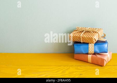 Gift boxes on wooden table. blue background Stock Photo