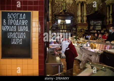 Moscow, Russia. 11th of April, 2021. A view of the fish section of the Yeliseyevsky store on the day of its closing. Considered Moscow's oldest grocery store, it was founded by merchant Grigory Yeliseyev back in 1901 as Eliseev's Shop and Cellars of Russian and Foreign Wines. On February 5 this year, the store marked 120 years since its opening. The banner reads 'Always on sale black caviar, red caviar' Stock Photo