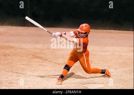 A Female Baseball Player Is Swinging For The Fences Stock Photo