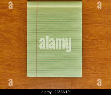 Top view of blank lined notebook open on a wooden desktop background Stock Photo
