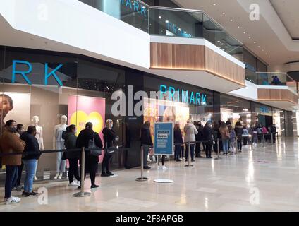 Peterborough, UK. 12th Apr, 2021. People queue outside the Primark store in the Queensgate Centre in Peterborough city centre this morning as non-essential shops, pubs and indoor sports venues can re-open today as more lockdown restrictions are eased today. Credit: Paul Marriott/Alamy Live News Stock Photo