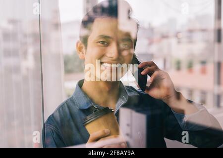 Asian man is working by the glass door Stock Photo
