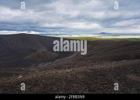 View of the Myvatn lake from the rim of Hverfjall volcano in northern Iceland on a cold, cloudy day. Volcanic landscape in the northern weather. Stock Photo