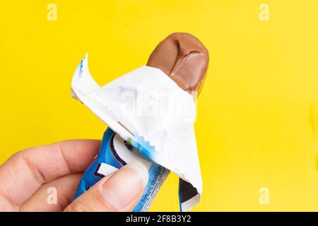 BELARUS, NOVOPOLOTSK - 12 APRIL, 2021: Bounty bar in hand on yellow background close up Stock Photo