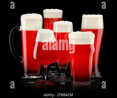 Set of fresh stout beer glasses with bubble froth isolated on black background. Stock Photo