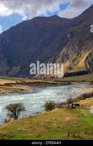 New Zealand river flows into the hills Stock Photo