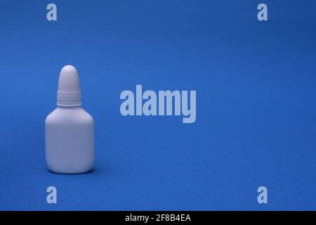 Nasal spray on a blue background. space for writing Stock Photo