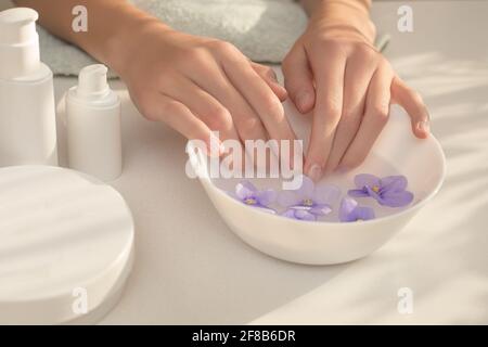 Elegant, well-groomed female hands with long fingers. Skin care procedure for hands, nails, manicure. Concept of Spa beauty salon. Mocap, plastic cont Stock Photo