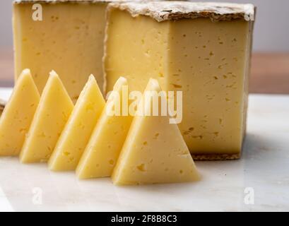 Cheese collection, Tomme de Savoie cheese from Savoy region in French Alps,  mild cow's milk cheese with beige interior and thick brownish-grey rind c Stock Photo