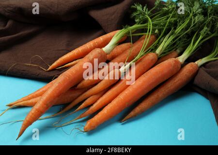 Kitchen towel with carrot on blue background Stock Photo