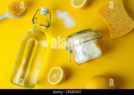 Cleaning concept with eco friendly cleaning tools and lemons on yellow background Stock Photo