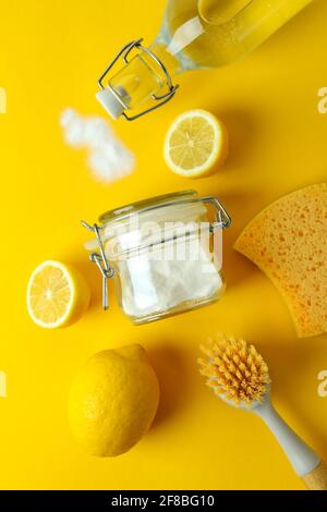 Cleaning concept with eco friendly cleaning tools and lemons on yellow background Stock Photo
