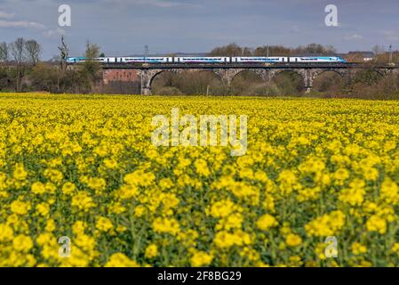A train crossing the Sankey viaduct at Earlestown over the Sankey Valley. Trans Pennine express train.  heading west towards Newcastle. Stock Photo