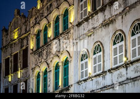 Details of facade of old French colonial buildings in Qilou or Zhongshan old street illuminated at night in Haikou old town in Hainan China Stock Photo