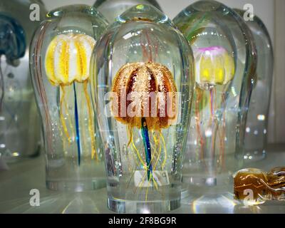 Cursed jellyfish in crystal glass. Glass paperweight and glassy ornament on the mantelpiece or director's office desk. Exhibition of handmade glass Stock Photo