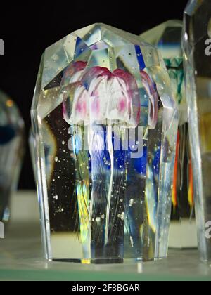 Cursed jellyfish in crystal glass. Glass paperweight and glassy ornament on the mantelpiece or director's office desk. Exhibition of handmade glass Stock Photo