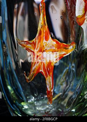 Art sea star in a glass vase. A fairytale world in crystal glass. Exhibition of handmade glass Stock Photo