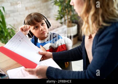 Mother checks her son's math homework Stock Photo