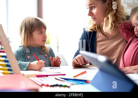 Close up of mother looking after daughters at home Stock Photo