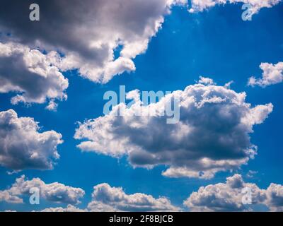 Clouds cover the sun light on the dark blue sky Stock Photo