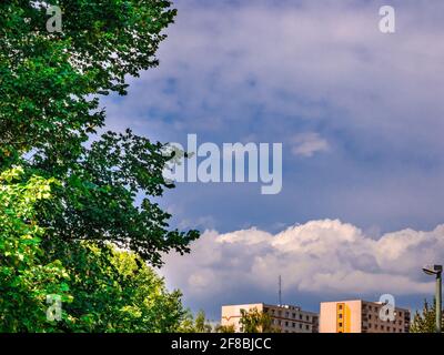 Massive clouds above the houses in the distance on the blue sky Stock Photo