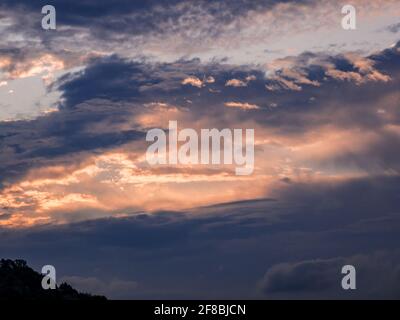Clouds and bright rift in the sky at sunrise Stock Photo