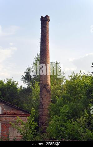 Older pipe boiler room on a background of clouds. Stock Photo