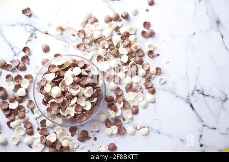 Top view of chocolate corn flakes in a bowl on tiles background  Stock Photo