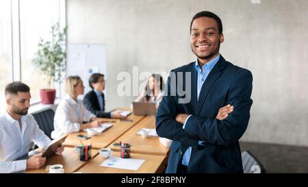 African American Male Entrepreneuer Smiling To Camera Posing In Office Stock Photo
