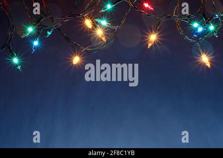 Christmas lights on blue background with copy space Stock Photo