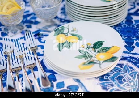 Navy blue and yellow table setting for outdoor wedding reception Stock Photo