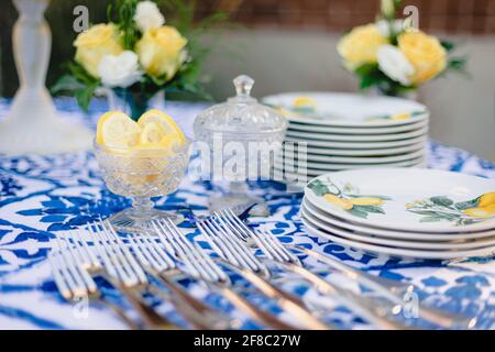 Navy blue and yellow table setting for outdoor wedding reception Stock Photo