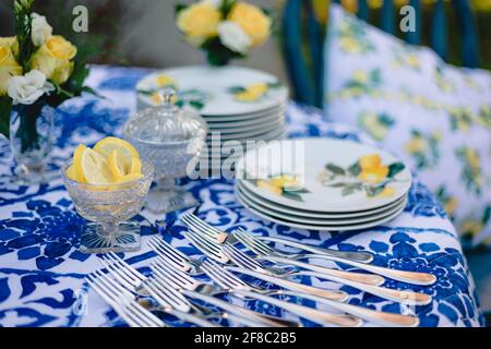 Navy blue and yellow table setting for outdoor wedding reception Stock Photo