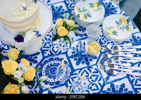 Navy blue and yellow table setting for outdoor wedding reception Stock Photo