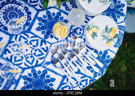Navy blue and yellow table setting for outdoor wedding reception Stock Photo