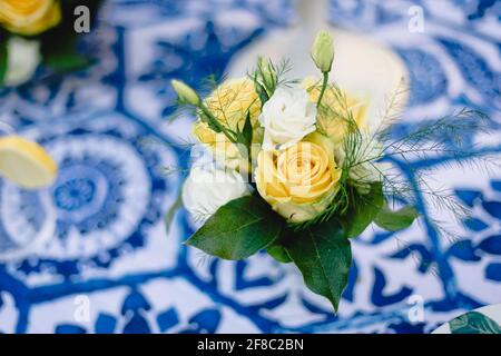 Navy blue and yellow table setting for outdoor wedding reception Stock Photo