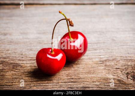 Ripe and juicy cherries on the dark rustic background. Selective focus. Shallow depth of field. Stock Photo