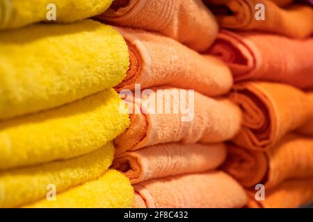 A stack of multi-colored bath towels close-up. Spa accessories for health care. Stock Photo