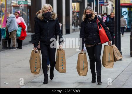 London, UK. 13 April 2021.  Women shopping in Oxford Street following the UK government’s coronavirus roadmap out of lockdown which allowed non-essential shops to reopen the previous day.  Credit: Stephen Chung / Alamy Live News Stock Photo