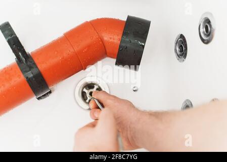 https://l450v.alamy.com/450v/2f8c7yg/plumber-using-drain-snake-to-unclog-bathtub-2f8c7yg.jpg