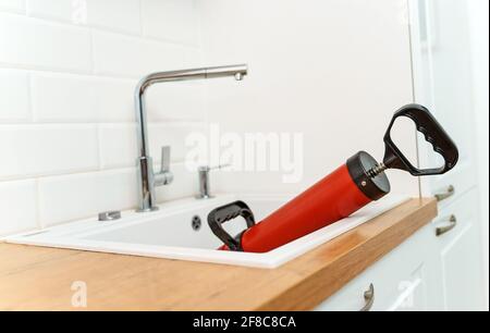 Professional force pump cleaner in the kitchen sink. Stock Photo