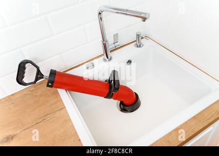 Professional force pump cleaner in the kitchen sink. Stock Photo