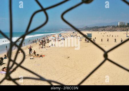 Santa Monica Beach through the broken fence Stock Photo