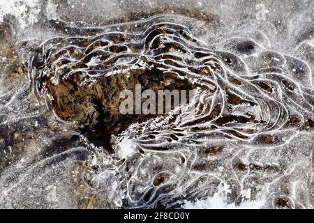 Nature’s creative elegance: Ice sculptures, ice flowers and hoar frost, combined with the clear waters and coloured rocks of the Yukon River. Stock Photo